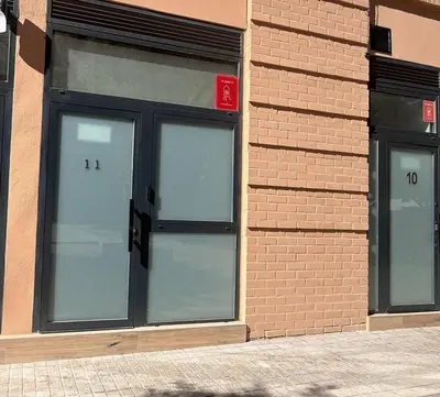 a bed with white pillows and a wooden headboard at Loft Valencia M11 - Ground & Arena Connected in Valencia