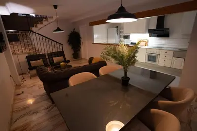 a living room with a dining table and chairs at Casa Boutique Playa y Valencia in El Puig