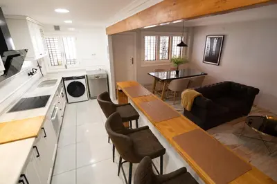 a kitchen and living room with a table and chairs at Casa Boutique Playa y Valencia in El Puig