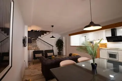 a kitchen and a living room with couches and a table at Casa Boutique Playa y Valencia in El Puig