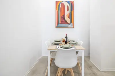 a white dining room with a white table and chairs at Modern & Stylish Apartment Close to the Beach in Valencia