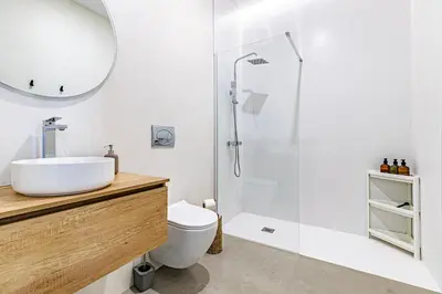 a white bathroom with a sink and a shower at Modern & Stylish Apartment Close to the Beach in Valencia