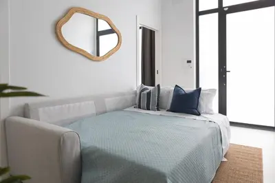 a bedroom with a bed with a mirror on the wall at Modern & Stylish Apartment Close to the Beach in Valencia