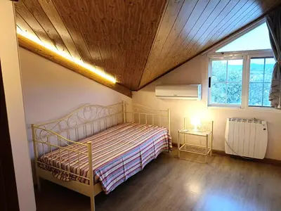 a bedroom with a bed with a wooden ceiling at La Villa Blanca in Pedralba