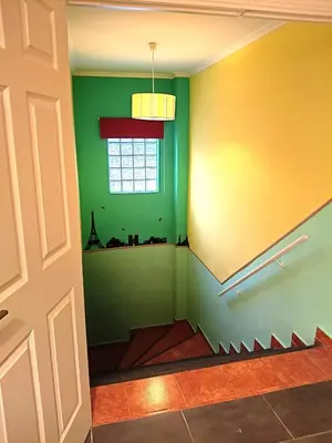 a room with green and yellow walls and a window at La Villa Blanca in Pedralba