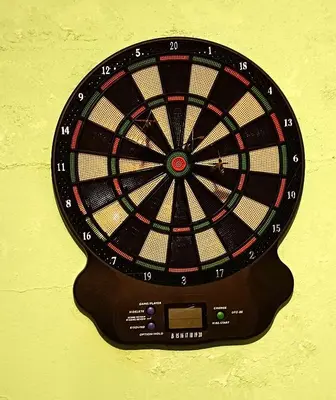 a dart board on a yellow wall at La Villa Blanca in Pedralba