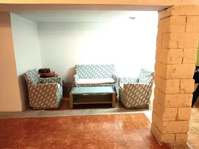 a living room with two chairs and a table at La Villa Blanca in Pedralba