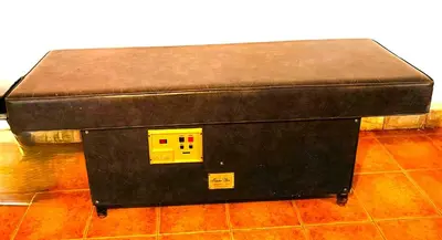 a black ottoman sitting on top of a floor at La Villa Blanca in Pedralba