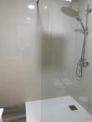 a bathroom with a shower with a glass door at Peixcateria mini in Sagunto