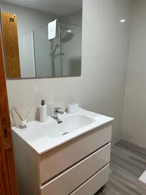 a bathroom with a white sink and a mirror at Peixcateria mini in Sagunto