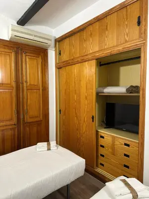 a room with two beds and a tv in a room at Peixcateria mini in Sagunto