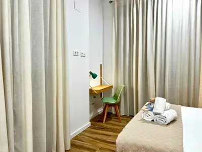 a room with a bed and a desk and a chair at Travel Habitat Santo Domingo Loft in Valencia