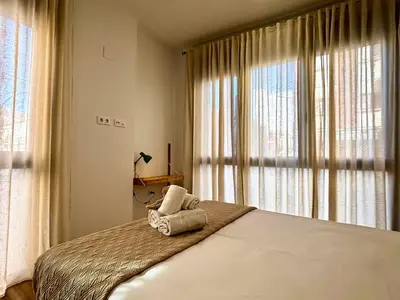 a bedroom with a bed with towels on it at Travel Habitat Santo Domingo Loft in Valencia