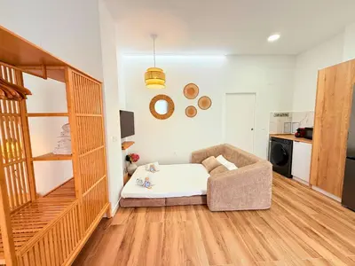 a living room with a couch and a kitchen at Travel Habitat Santo Domingo Loft in Valencia