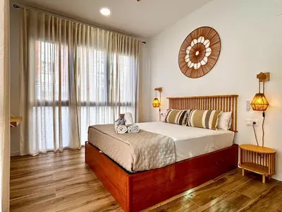 a bedroom with a large bed and a mirror at Travel Habitat Santo Domingo Loft in Valencia