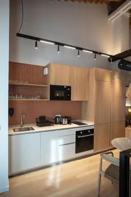 a kitchen with white appliances and wooden cabinets at Mon Suites San Pedro in Valencia