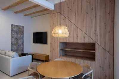 a dining room with a table and a couch at Mon Suites San Pedro in Valencia