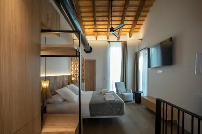 a bedroom with a bunk bed and a room with a desk at Mon Suites San Pedro in Valencia