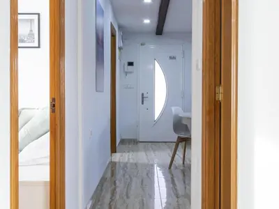 a hallway with a room with a bed and a mirror at Winahost Villa Unión in Puebla de Vallbona