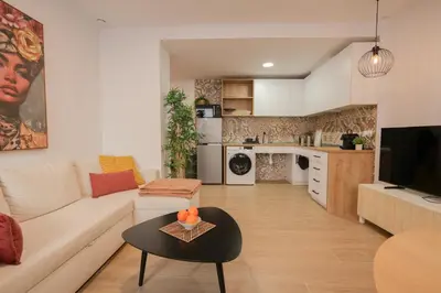 a living room with a couch and a table at Casa Estrellita Boutique Apartment in Valencia