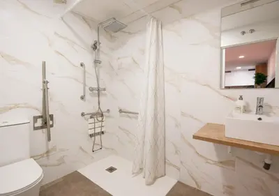 a bathroom with a shower and a toilet and a sink at Casa Estrellita Boutique Apartment in Valencia