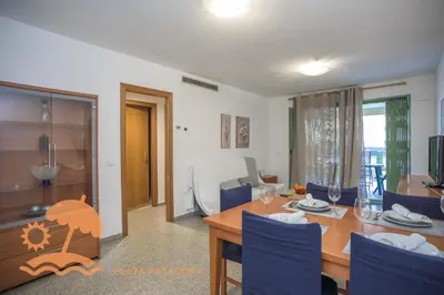 a dining room and living room with a table and chairs at Holiday Mare Nostrum in Valencia