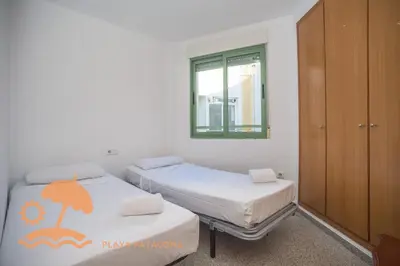 a bedroom with two beds and a window at Holiday Mare Nostrum in Valencia