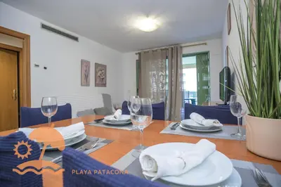 a dining room with a table with wine glasses at Holiday Mare Nostrum in Valencia
