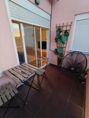 a balcony with a table and chairs on a house at Malvarrosa Penthouse 4 rooms, suite, terrace and balcony in Valencia