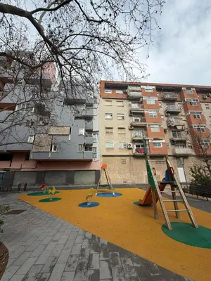 a playground with play equipment in front of a building at Malvarrosa Penthouse 4 rooms, suite, terrace and balcony in Valencia