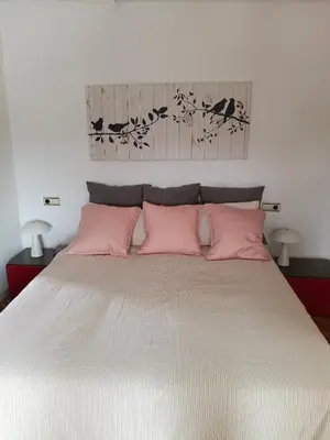 a bedroom with a large bed with pink pillows at Malvarrosa Penthouse 4 rooms, suite, terrace and balcony in Valencia