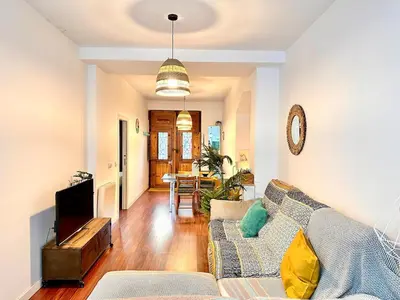 a living room with a couch and a table at Padre Anton seasonal apartment in Valencia