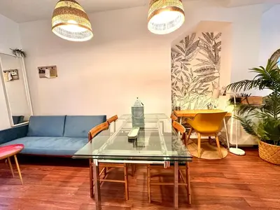 a living room with a blue couch and a table at Padre Anton seasonal apartment in Valencia