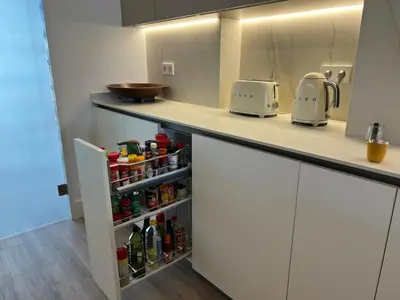 a kitchen with a counter top with bottles at Bright spacious luxury apartment in Valencia