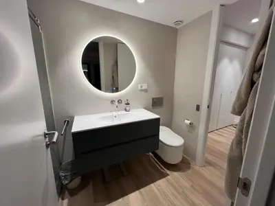 a bathroom with a sink and a toilet and a mirror at Bright spacious luxury apartment in Valencia