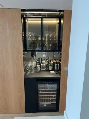 a kitchen with a counter with bottles and alcohol at Bright spacious luxury apartment in Valencia