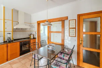a kitchen with a table and chairs in a room at Villa Azahar - Mediterranean Retreat in Benifayó