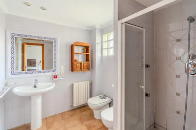 a bathroom with a sink and a toilet and a shower at Villa Azahar - Mediterranean Retreat in Benifayó