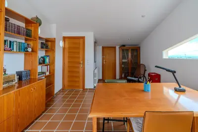 a kitchen with a wooden table and a desk at Villa Azahar - Mediterranean Retreat in Benifayó
