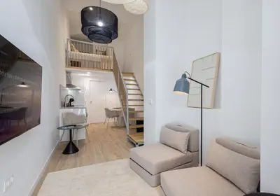 a living room with a couch and a chair at Loft Valencia M15 - Ground & Arena Connected in Valencia