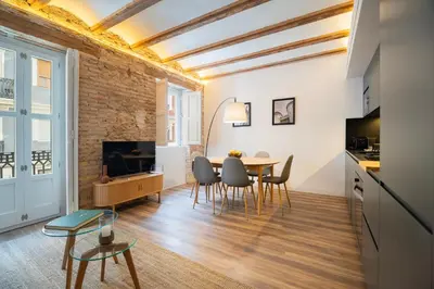 a kitchen and dining room with a table and chairs at Borrull Historic Center Premiere in Valencia