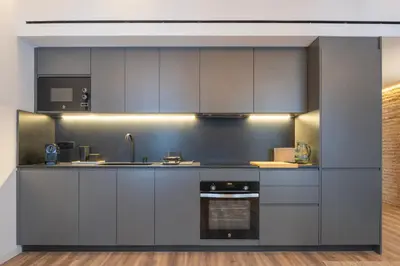 a kitchen with gray cabinets and a stove at Borrull Historic Center Premiere in Valencia