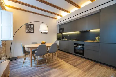 a kitchen and dining room with a table and chairs at Borrull Historic Center Premiere in Valencia