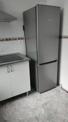 a kitchen with a stainless steel refrigerator in a room at Carmen & Alejandro Home in Valencia