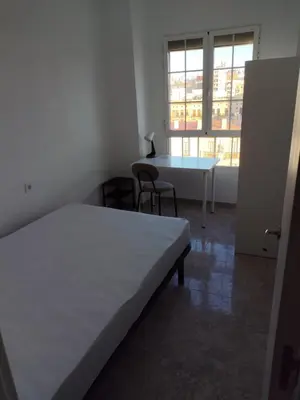 a room with a bed and a table and chairs at Carmen & Alejandro Home in Valencia