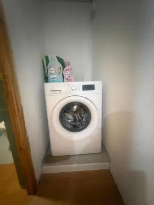 a washer and dryer in a corner of a room at Danner in Valencia