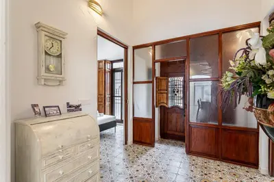a room with a hallway with a clock on the wall at GuestReady - Traditional House near Malvarrosa in Valencia