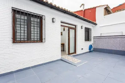 a white building with a door and a patio at GuestReady - Traditional House near Malvarrosa in Valencia