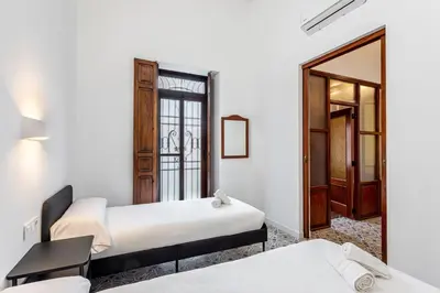 a room with two beds and a mirror at GuestReady - Traditional House near Malvarrosa in Valencia