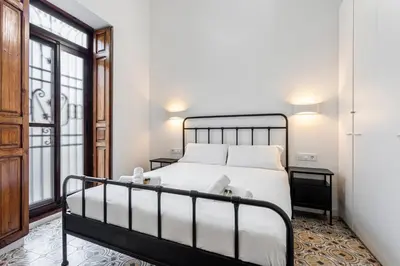 a bedroom with a bed and a window at GuestReady - Traditional House near Malvarrosa in Valencia